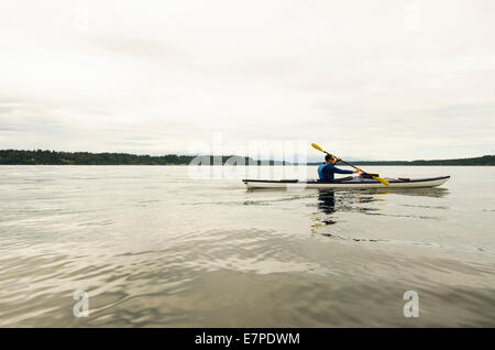 USA, Washington State, Olympia, Man kayaking on lake Stock Photo