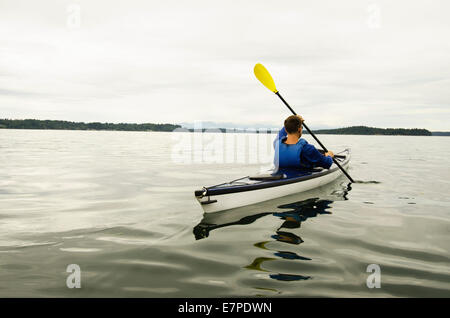 Man kayaking on lake Stock Photo