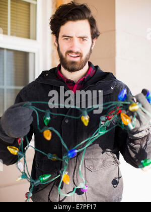 Front view portrait of young man with Christmas light Stock Photo