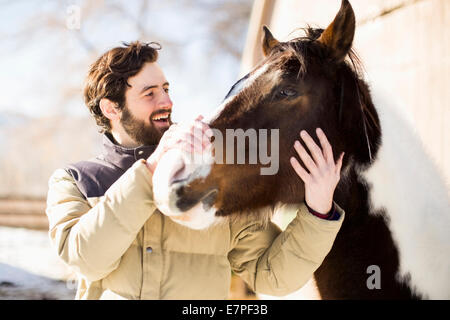 USA, Utah, Salt Lake City, Man stroking horse Stock Photo