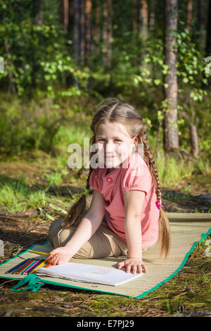 Little girl drawing outdoors Stock Photo