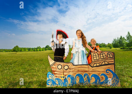 Pirate with sword and two princesses stand on ship Stock Photo
