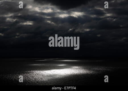 Sun shining through clouds on the ocean off the west Coast of Cape Breton Island, Nova Scotia, Canada Stock Photo