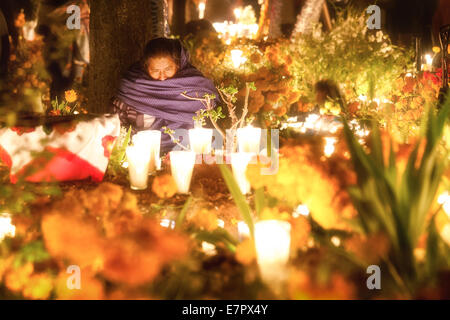 A widow keeps wake during Day of the Dead in Tzintzuntzan, Michoacan, Mexico. Stock Photo