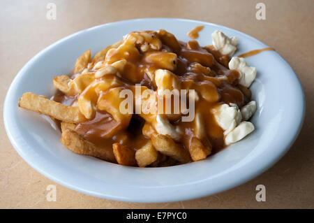 The famous 'traditional' poutine at Le Roy Jucep restaurant in Drummondville, Quebec, Canada. Stock Photo