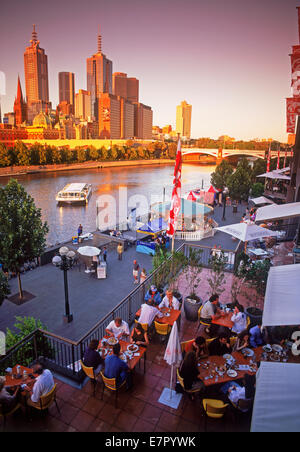 Dining at Southgate Complex on the Yarra River under Melbourne Skyline near sunset Stock Photo