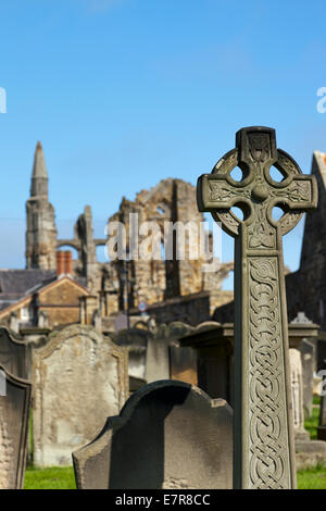 Graveyard of Church of Saint Mary with Whitby Abbey in the background Stock Photo