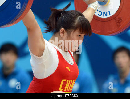 Incheon, South Korea. 23rd Sep, 2014. Deng Wei of China competes during the women's 63kg of weightlifting at the 17th Asian Games in Incheon, South Korea, Sept. 23, 2014. Deng Wei won the silver medal. © Ma Ping/Xinhua/Alamy Live News Stock Photo