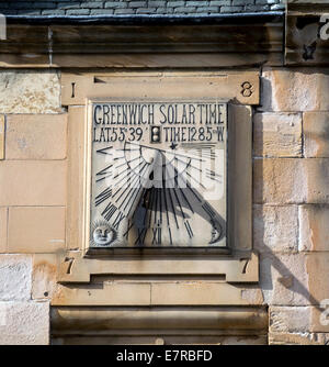 This unusual 1877 Greenwich solar time piece is built into a wall in the main street in Peebles, Scotland. Stock Photo