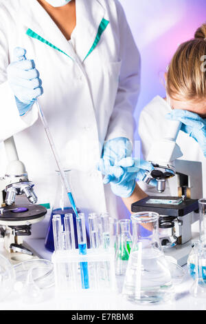 Two scientists in the chemical laboratory are doing experiments Stock Photo