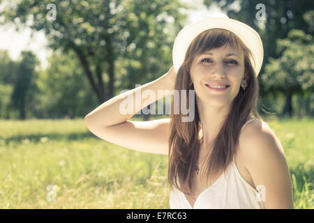 Young hipster cheerful woman take a fun in summer park. Travel outdoor background. Warm color toned image