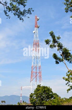 Tower relay signal and tree on blue sky background Stock Photo