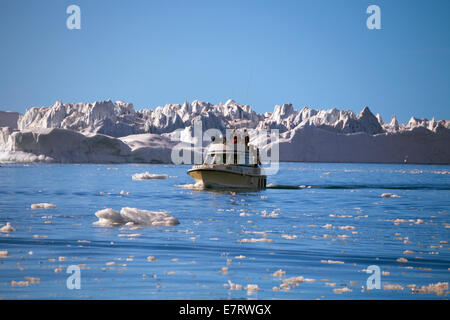 Tour boats offer a close-up look at the giant icebergs that choke Disko Bay, near Ilulissat, Greenland, Arctic Stock Photo
