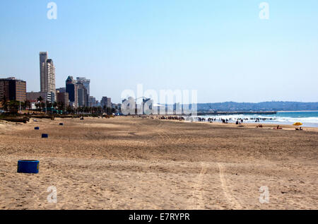 DURBAN, SOUTH AFRICA - SEPTEMBER 21, 2014: Many unknown people enjoy  early morning at Addington beach against city skyline in D Stock Photo