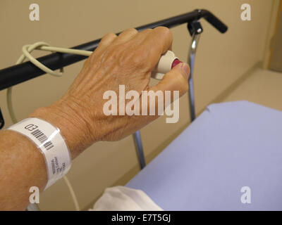Woman buzzes call button in hospital emergency room Stock Photo