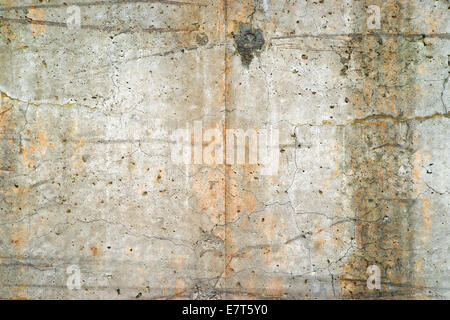 An old poured concrete exterior retaining wall weathered and stained with age. Stock Photo