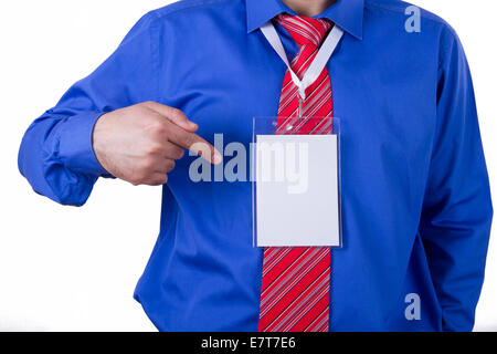 Businessman with red tie and blue shirt showing blank, empty, white name tag with his index finger, isolated on white background Stock Photo