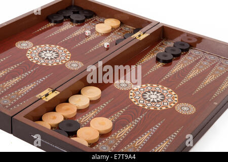 Backgammon table, chips and dices during the game, isolated on white background. Stock Photo