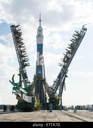The gantry arms begin to close around the Soyuz TMA-14M spacecraft at the Baikonur Cosmodrome September 23, 2014 in Kazakhstan. Launch of the Soyuz rocket is scheduled for Sept. 26 and will carry Expedition 41 crew to the International Space Station for a five and a half month mission. Stock Photo