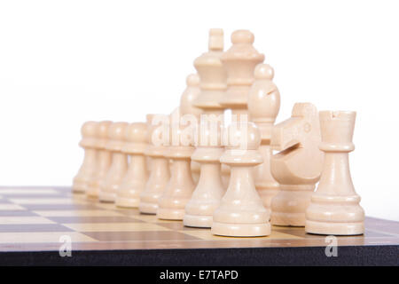 Chess board with starting positions aligned wooden chess pieces, isolated on white background. Stock Photo