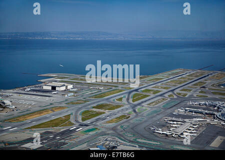 Planes, terminals and runways at San Francisco International Airport, San Francisco, California, USA - aerial Stock Photo