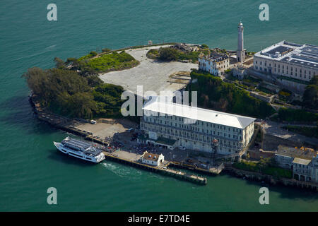 Tourists and ferry, Alcatraz Island, former high-security federal prison, San Francisco Bay, California, USA - aerial Stock Photo