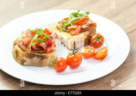 Fresh Bruschetta Sandwich With Bacon, Rucola And Tomatoes Stock Photo