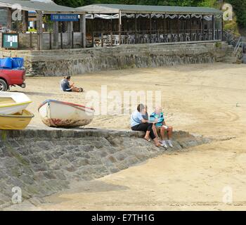 People sitting and relaxing in Newquay Harbour Cornwall England uk Stock Photo