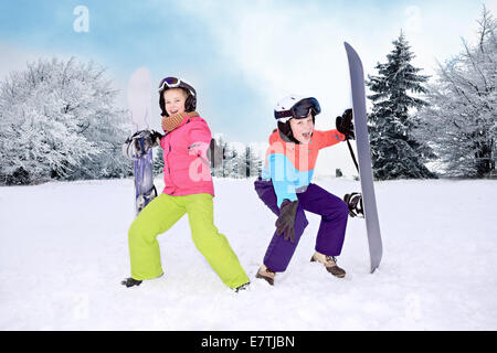 teenage girls snowboarding in the Alps. Stock Photo