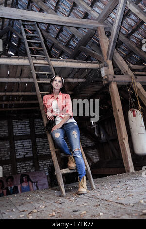 portrait of a young woman in the old barn Stock Photo