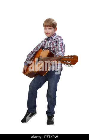 Boy stands with big acoustic guitar in hands isolated on white background Stock Photo