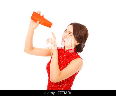 surprised asian young woman point to a empty red envelope over white background Stock Photo