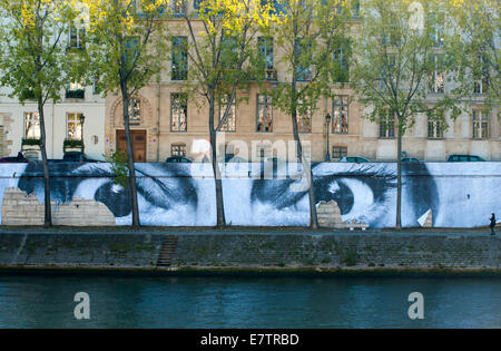 Eyes painted on a wall along the Seine River in Paris on the Ile Saint Louis Stock Photo