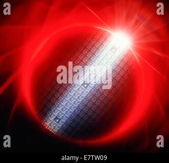 Semiconductor wafer. Image of a circular semiconductor wafer. The band of light illuminates some of the blocks of integrated circuits (IC) known as chips" on the silicon wafer. The ICs are formed on the thin silicon wafer by various deposition and etchi Stock Photo