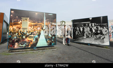 Berlin, Germany. 24th Sep, 2014. Visitors look at historic pictures on display on large panels at the former border crossing on Bornholmer Strasse (today known as the square 'Platz des 9th November') in Berlin, Germany, 24 September 2014. Berlin is commemorating the 25th anniversary of the Fall of the Berlin Wall on 9 November 2014. Photo: STEPHANIE PILICK/dpa/Alamy Live News Stock Photo