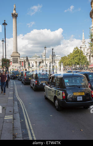 Central London, UK. 24th September 2014. Black cab taxi drivers protest TfL’s taxi policies today by driving in central London at a snails pace around 2pm. Areas affected are around Parliament Square, Whitehall and Trafalgar Square. Credit:  Malcolm Park editorial/Alamy Live News. Stock Photo