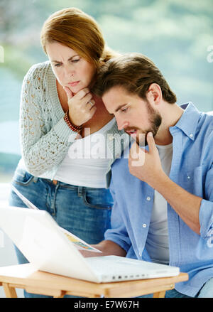 Couple working out finances Stock Photo