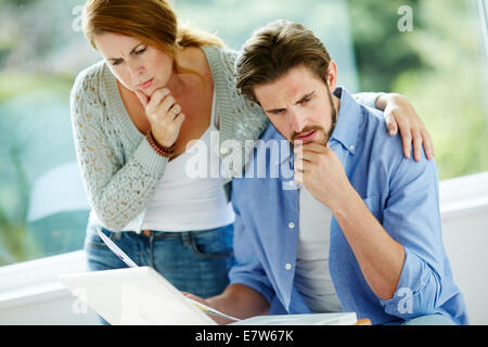 Couple working out finances Stock Photo