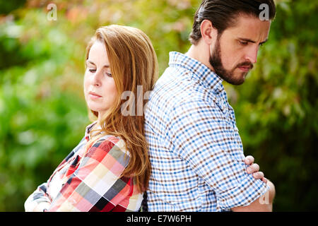 Couple stood back to back Stock Photo