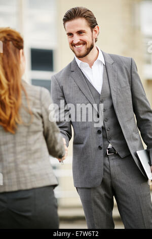 Two business people greeting each other Stock Photo