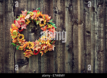 Autumn flower wreath against rustic wooden planks Stock Photo