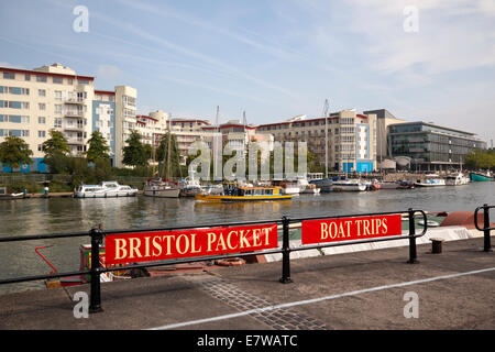 Advertising Bristol Packet Boat Trips on Bristol harbourside with views of waterside modern housing and offices. City of Bristol, England, UK Stock Photo