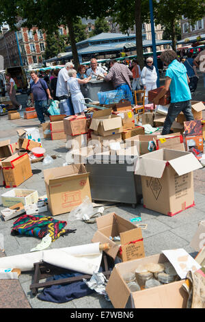 People looking through bins at a market in Rouen, France Europe Stock Photo