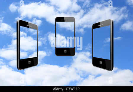 three modern mobile phones on the cloudy sky Stock Photo