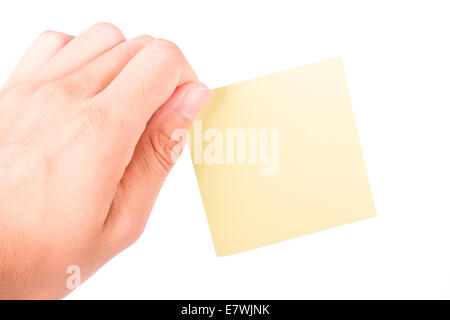 Hand holding blank, empty, yellow sticky post it note with copy space, isolated on white background. Stock Photo