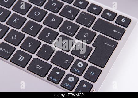 Dark color keyboard, focused on enter key, isolated on white background. Stock Photo