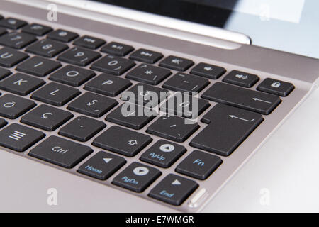 Laptop keyboard focused on enter key. Stock Photo