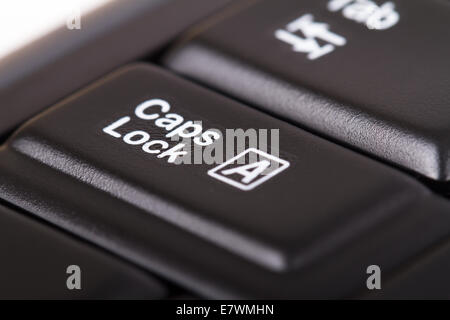 Close up view of caps lock key on black keyboard. Stock Photo