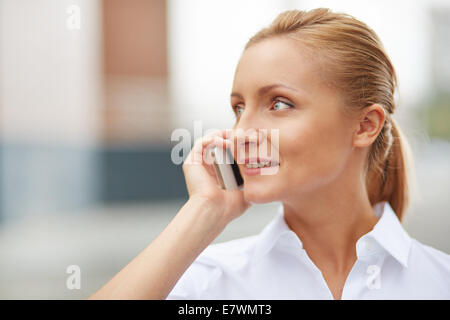 Portrait of smiling businesswoman speaking on the cellular phone Stock Photo