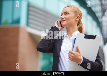 Successful employee or manager talking on cellphone outside Stock Photo